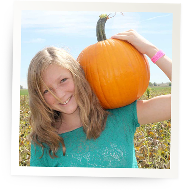 girl with pumpkin on shoulder