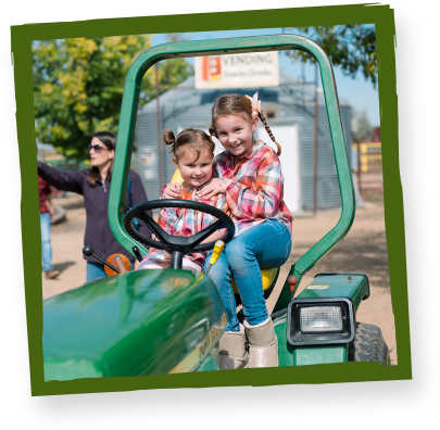 girls riding on tractor